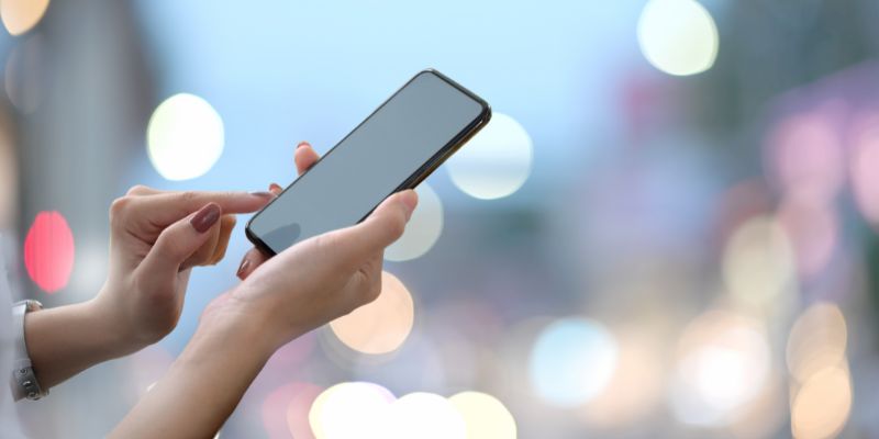 A woman using a mobile phone.